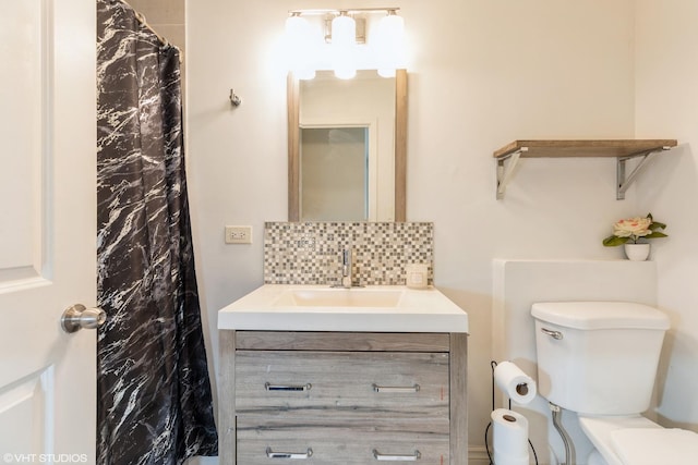 bathroom with tasteful backsplash, vanity, curtained shower, and toilet