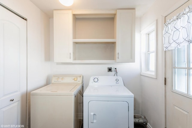 washroom featuring cabinets and independent washer and dryer