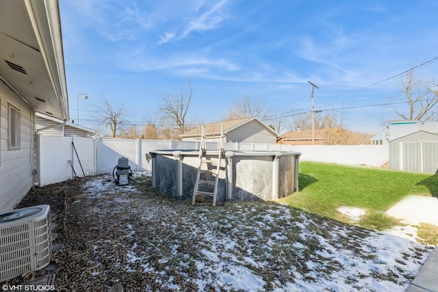 snowy yard with cooling unit and a fenced in pool