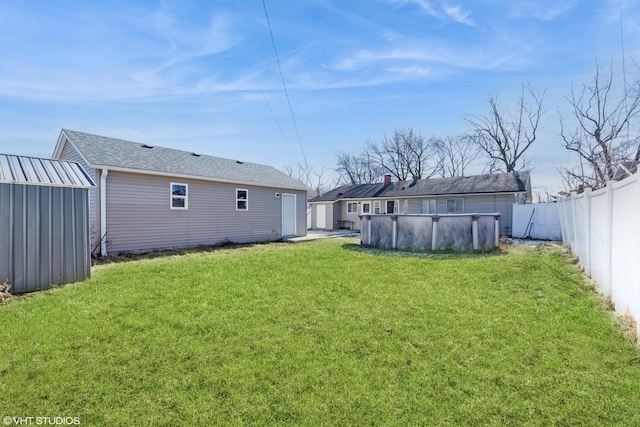 view of yard with an outdoor structure and a covered pool