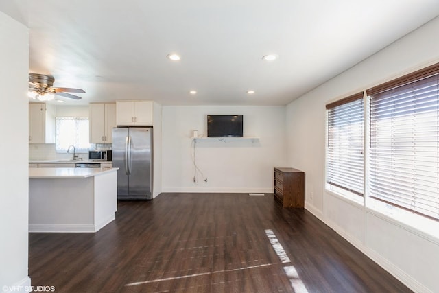 kitchen with stainless steel appliances, tasteful backsplash, dark hardwood / wood-style floors, and white cabinetry