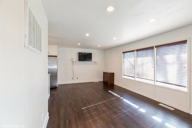 unfurnished living room featuring dark hardwood / wood-style flooring