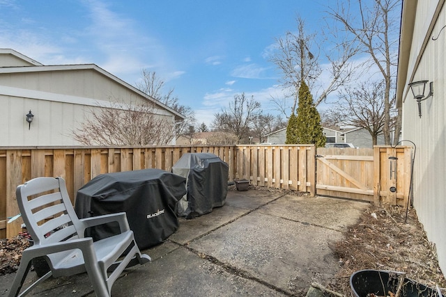 view of patio featuring a gate, fence, and area for grilling