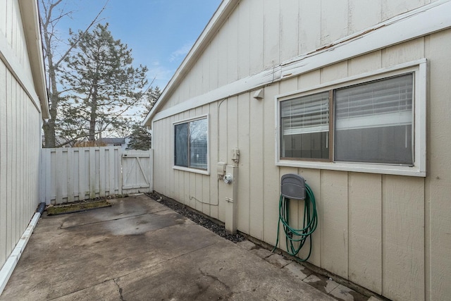 view of home's exterior featuring a patio area and fence