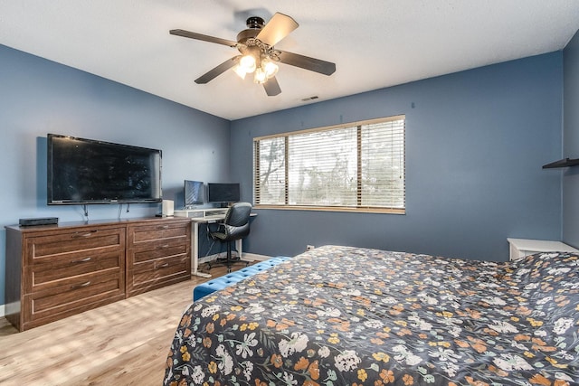 bedroom featuring visible vents, ceiling fan, baseboards, and wood finished floors