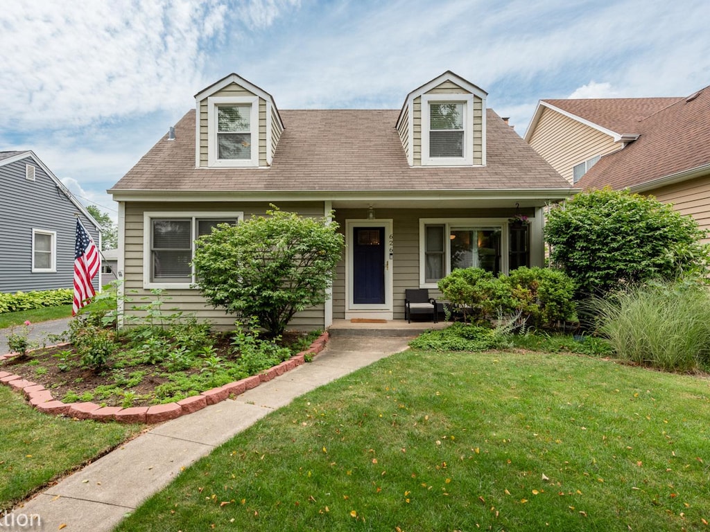 cape cod-style house with a front yard and a porch