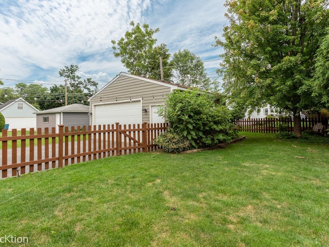 view of yard with a garage and an outdoor structure