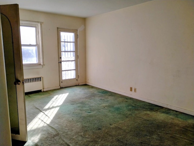 carpeted empty room with radiator