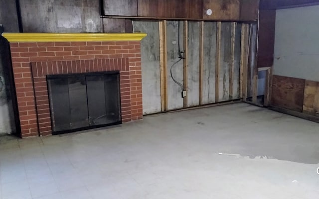 basement featuring a brick fireplace