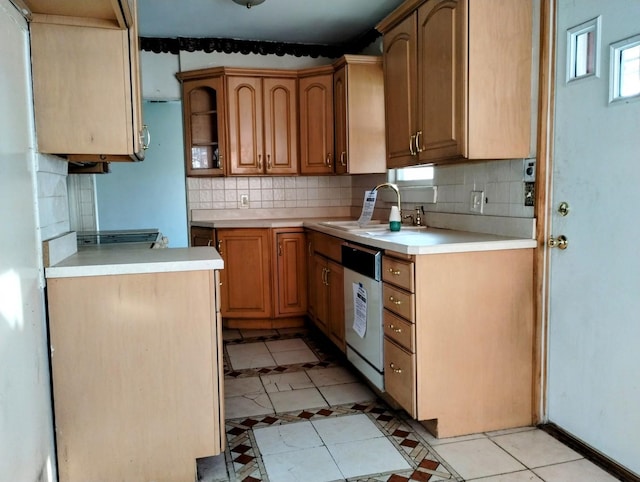 kitchen featuring sink, stainless steel dishwasher, decorative backsplash, and light tile patterned floors