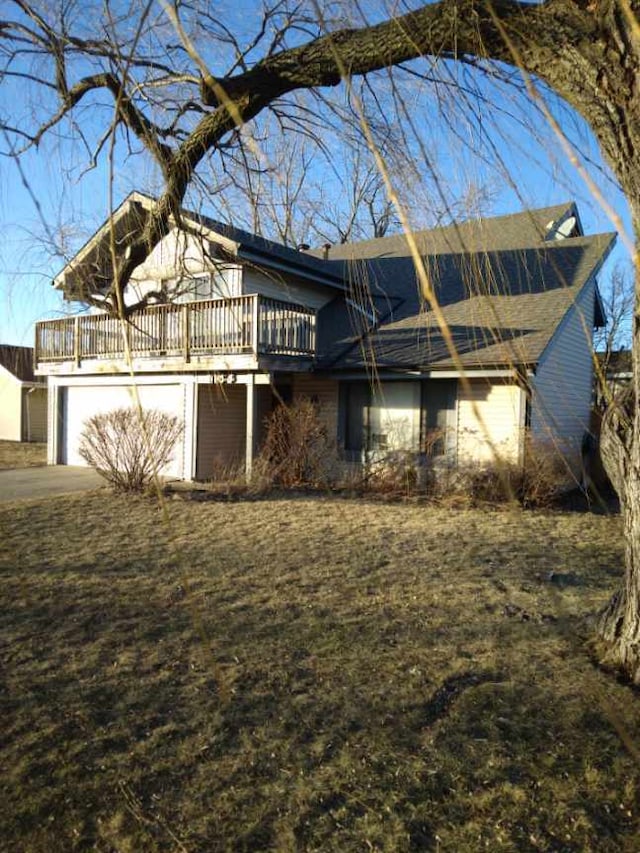 view of home's exterior featuring a garage and a deck