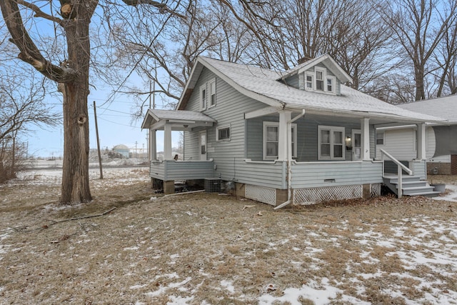 view of snowy exterior featuring covered porch