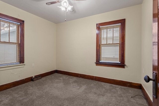 carpeted empty room with ceiling fan and a healthy amount of sunlight