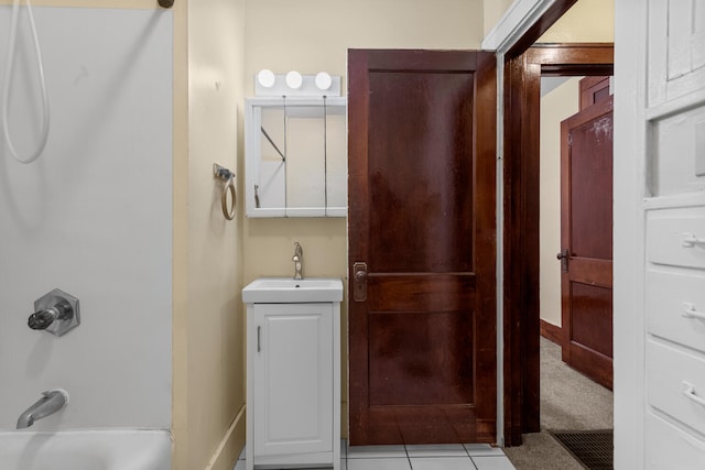 bathroom with tile patterned flooring, vanity, and tub / shower combination