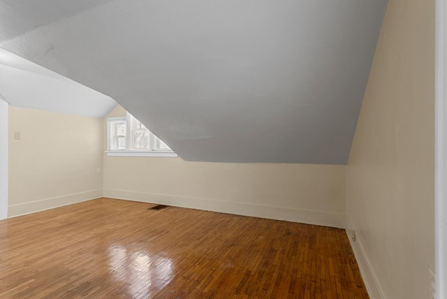 bonus room featuring lofted ceiling and wood-type flooring