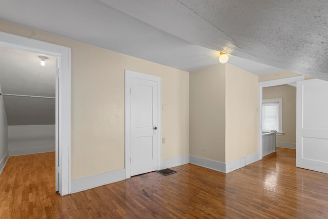 interior space with hardwood / wood-style floors and a textured ceiling