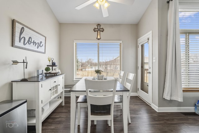 dining area featuring ceiling fan, baseboards, and dark wood-style floors