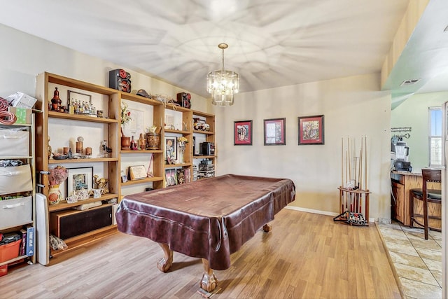 game room with pool table, visible vents, light wood finished floors, and an inviting chandelier