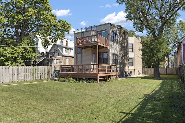 back of property featuring a fenced backyard, a lawn, and a deck