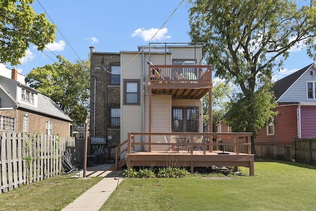 back of property featuring a fenced backyard, a lawn, and a wooden deck