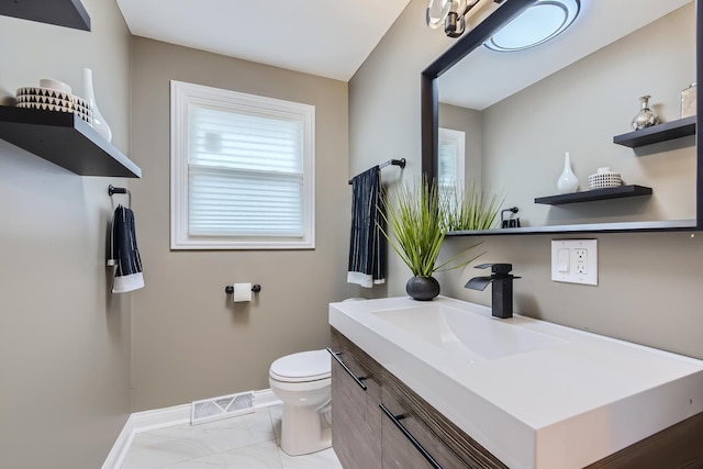 bathroom featuring vanity and toilet