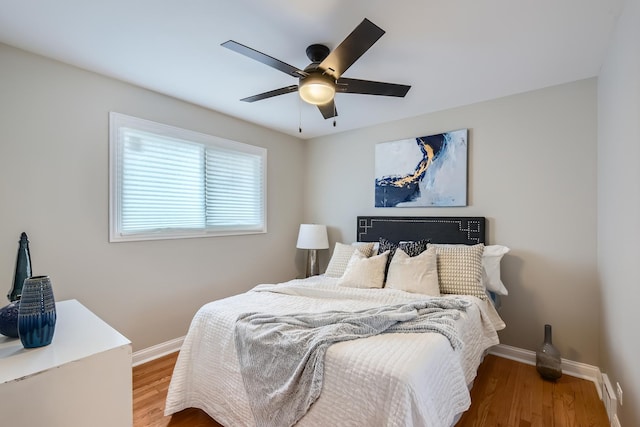 bedroom with ceiling fan and wood-type flooring