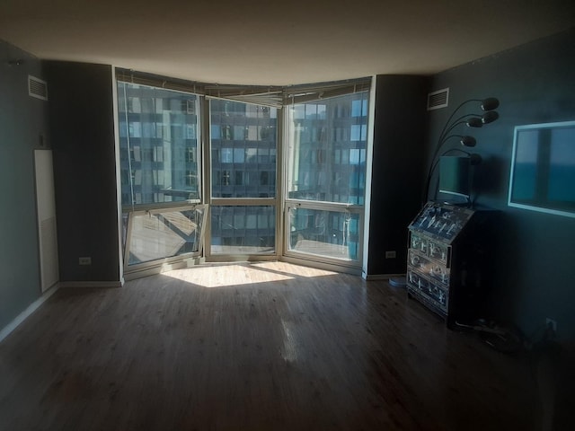 interior space featuring hardwood / wood-style flooring and a wall of windows