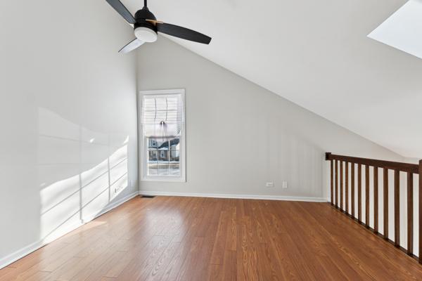 bonus room featuring ceiling fan, lofted ceiling, and wood-type flooring