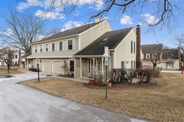 view of front of property with a garage and a front yard