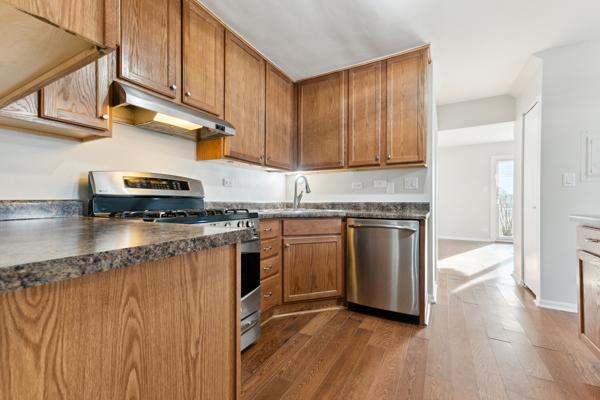 kitchen featuring dark hardwood / wood-style flooring, sink, and stainless steel appliances