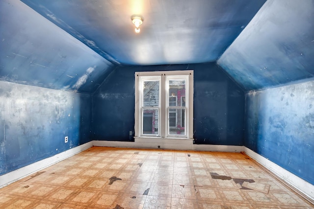 additional living space featuring lofted ceiling