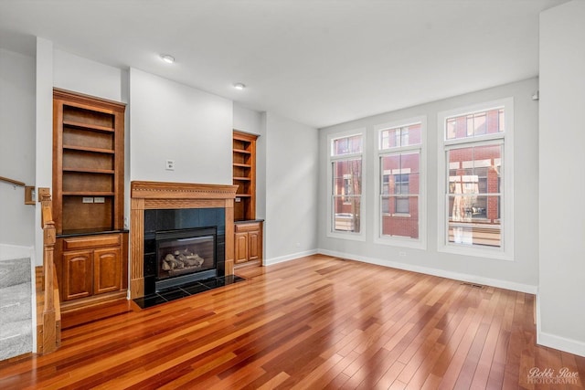 unfurnished living room featuring a fireplace and hardwood / wood-style floors