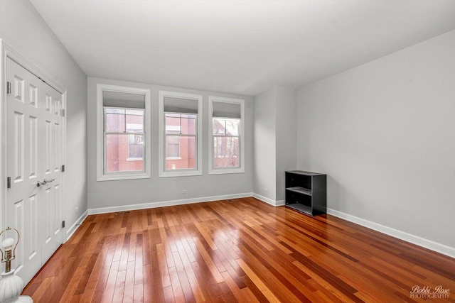 empty room with hardwood / wood-style floors