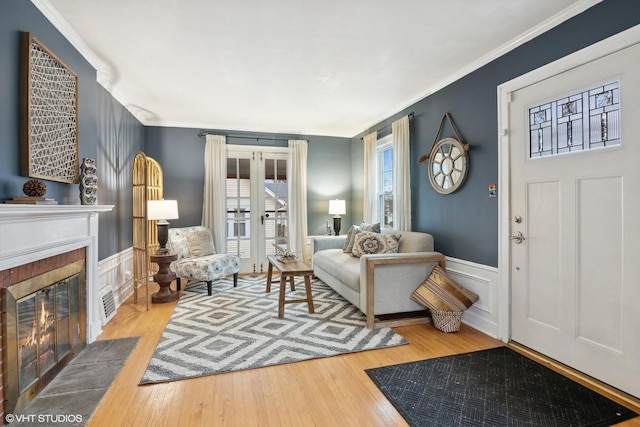 interior space featuring hardwood / wood-style floors, ornamental molding, and french doors