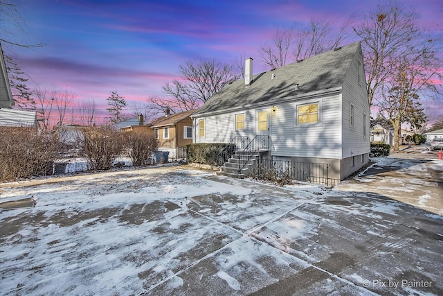 view of snow covered rear of property