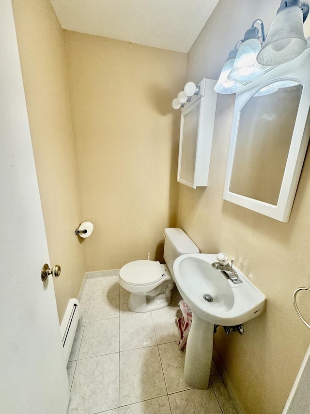 bathroom featuring sink, tile patterned floors, toilet, and baseboard heating