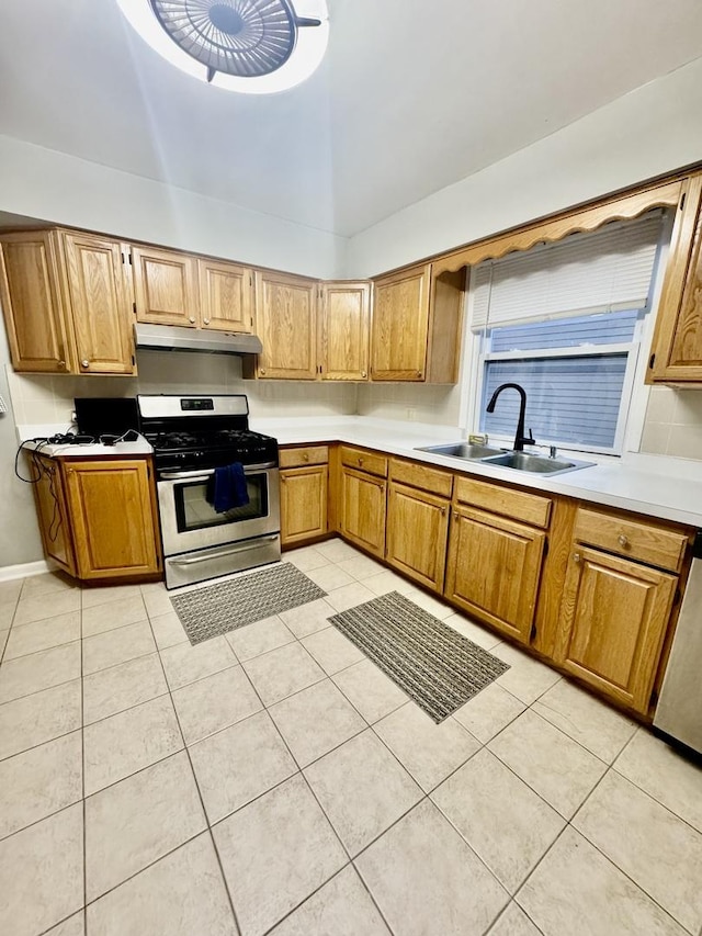 kitchen with sink, stainless steel appliances, and light tile patterned flooring