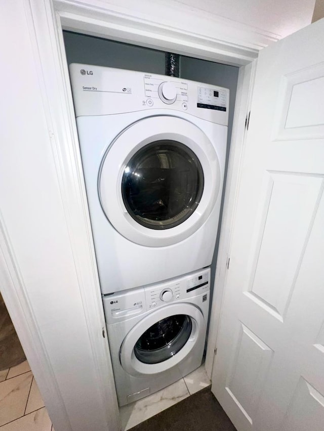 laundry area with stacked washer and dryer