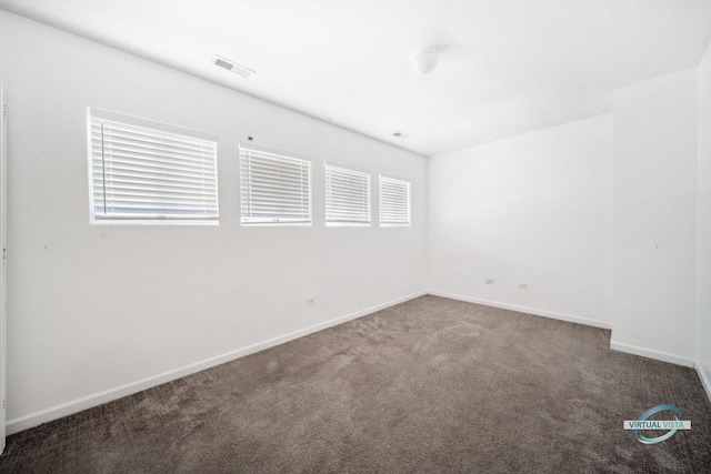 carpeted spare room with a healthy amount of sunlight