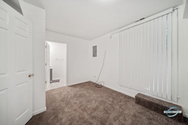 empty room with carpet flooring and electric panel