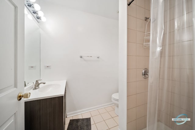 bathroom featuring tile patterned flooring, vanity, toilet, and walk in shower