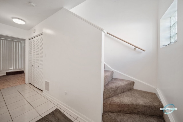 staircase with tile patterned floors