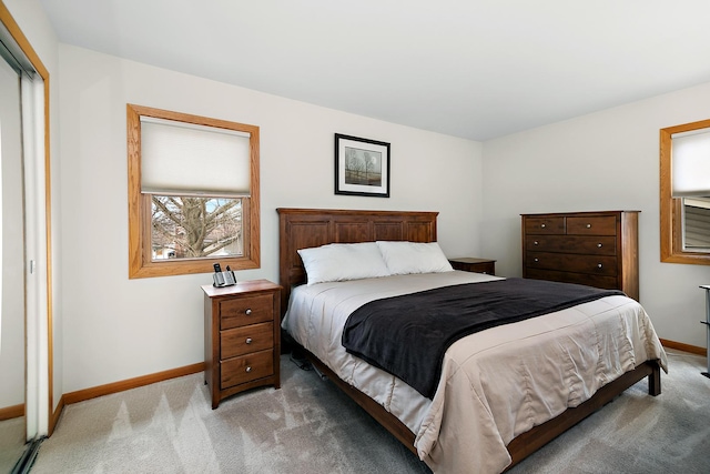 bedroom with light colored carpet and a closet