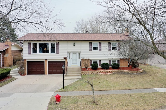 raised ranch with a garage and a front yard