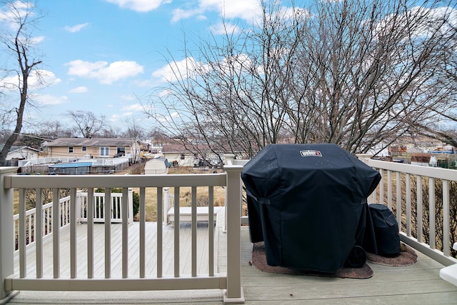 wooden deck featuring a grill