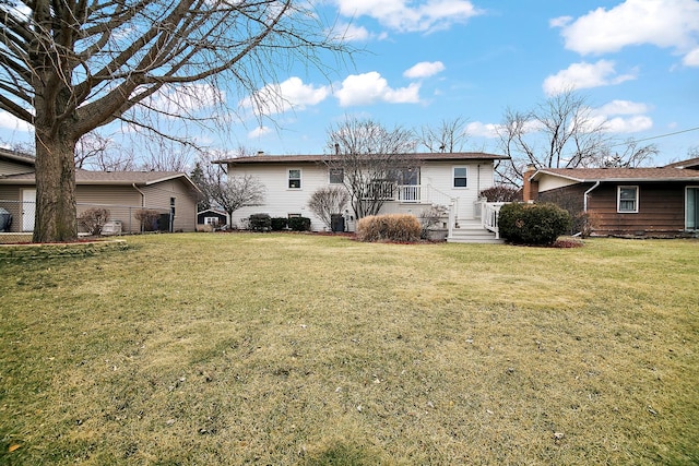 back of property featuring a lawn