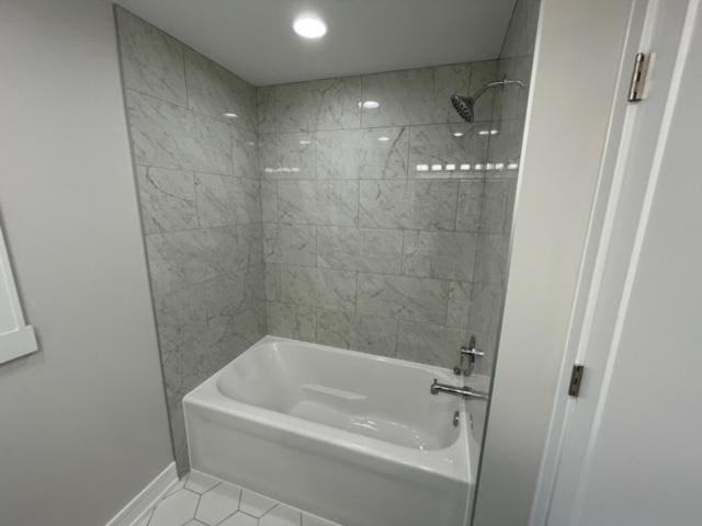 bathroom featuring tile patterned floors and tiled shower / bath