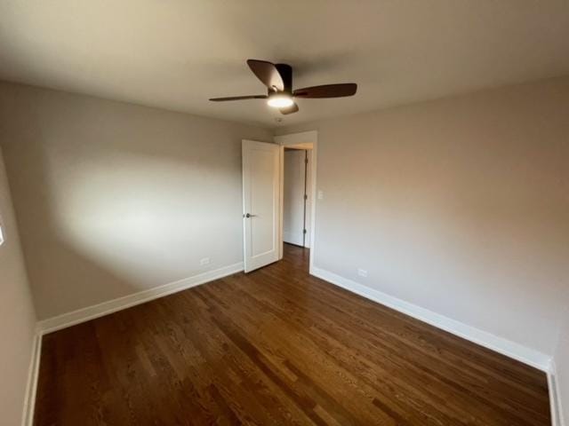 unfurnished room featuring dark hardwood / wood-style floors and ceiling fan