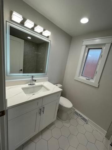 bathroom featuring vanity, a shower, tile patterned floors, and toilet