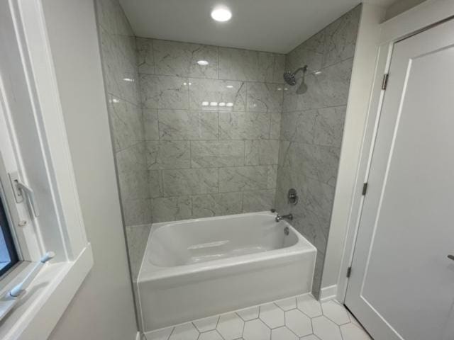 bathroom with tile patterned flooring and tiled shower / bath